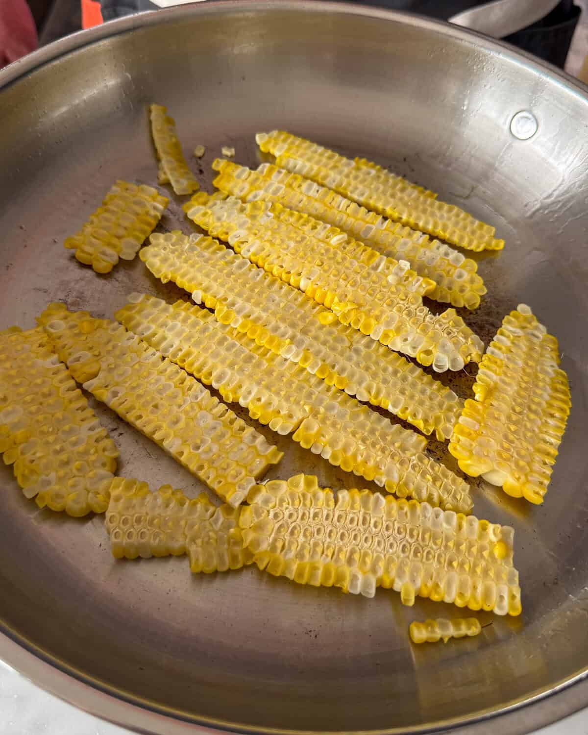 Place corn slabs cut-side down and press gently with a spatula to sear.