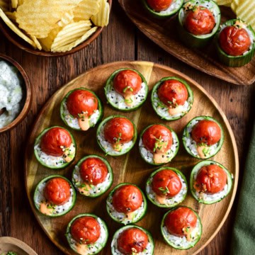 A platter of Warm Smokie Popper Sushi Bites in Cucumber Cups. Served with chips and a cucumber dip.