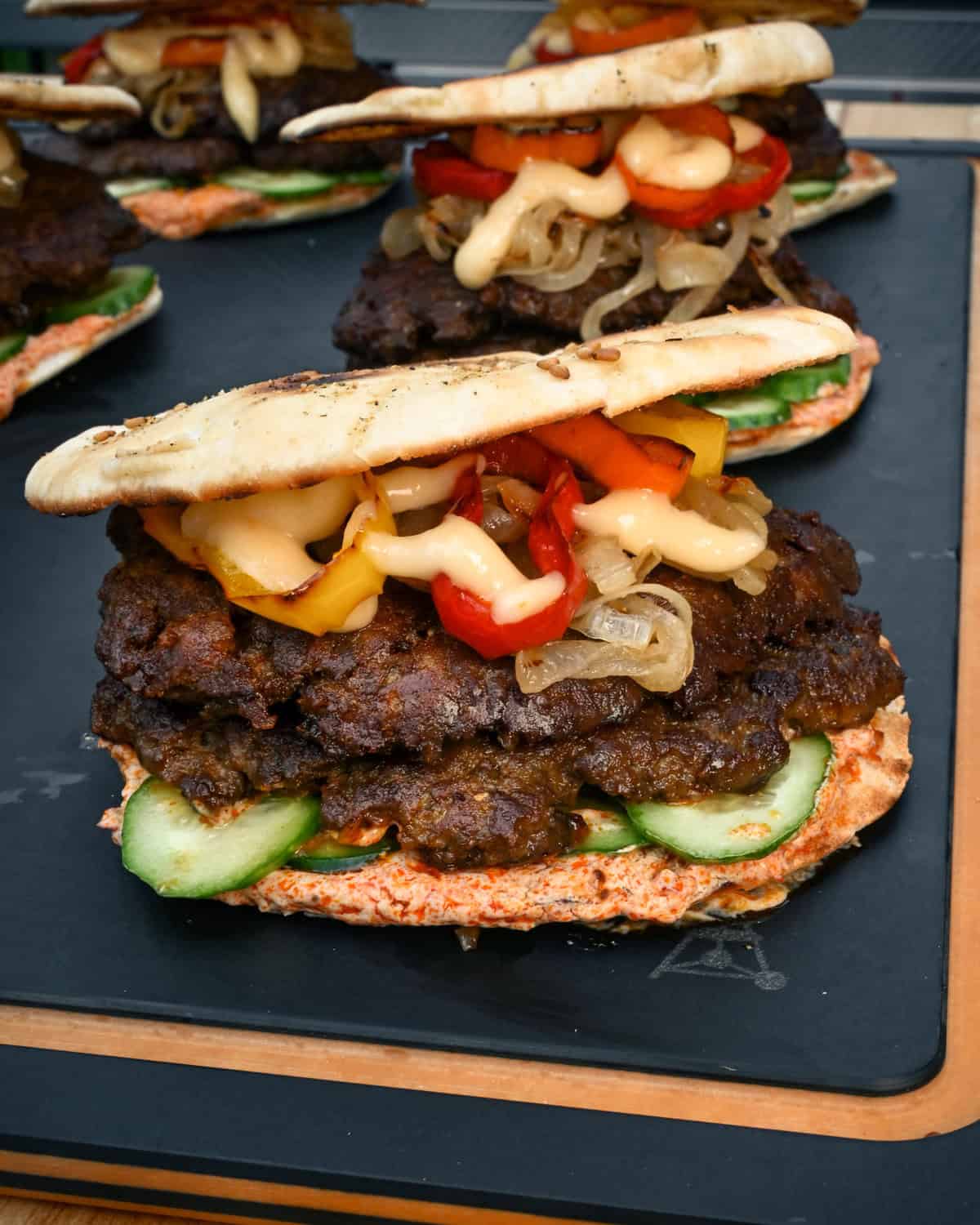 A side view of a Shawarma-Spiced Lamb Smash Sliders with Garlic Toum.