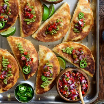 Cheesy Chorizo Quesadillas with Corn and Manchego. Served with guacamole, pico de gallo and sliced jalapenos.
