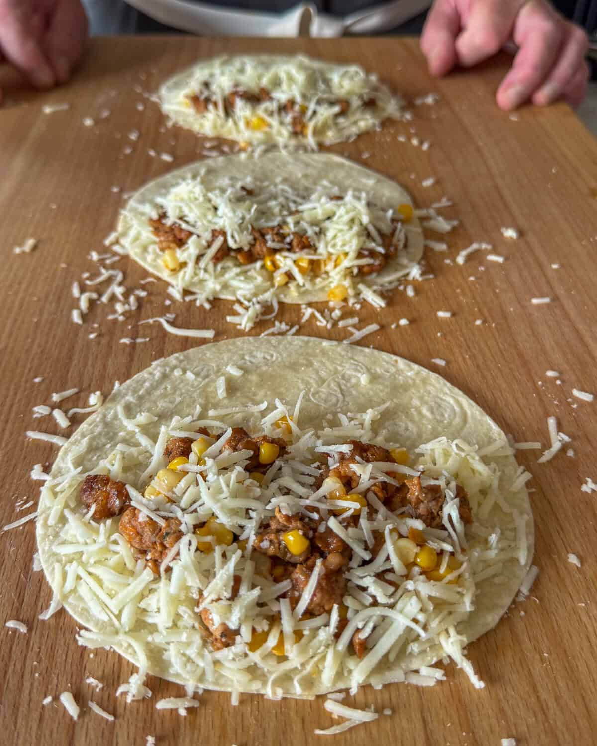 Top chorizo quesadillas with more corn and close.