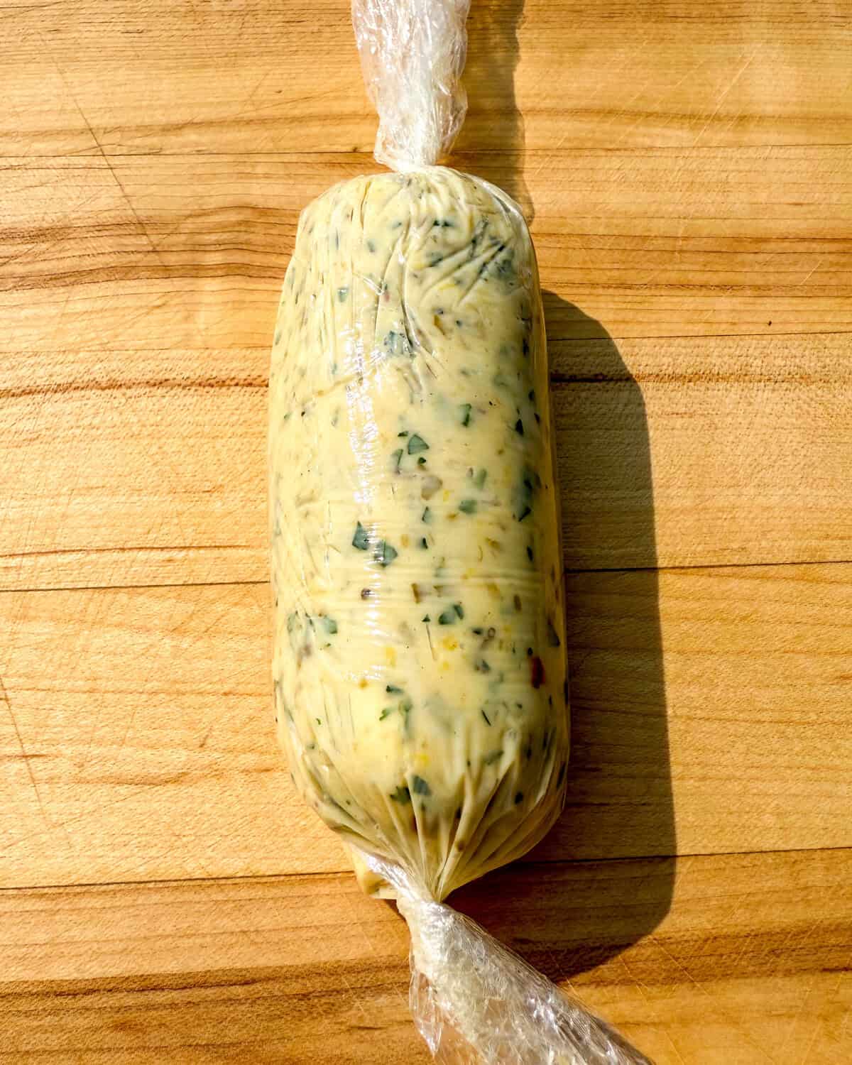 Dijon Caper Lemon Butter rolled in parchment paper to form a log.