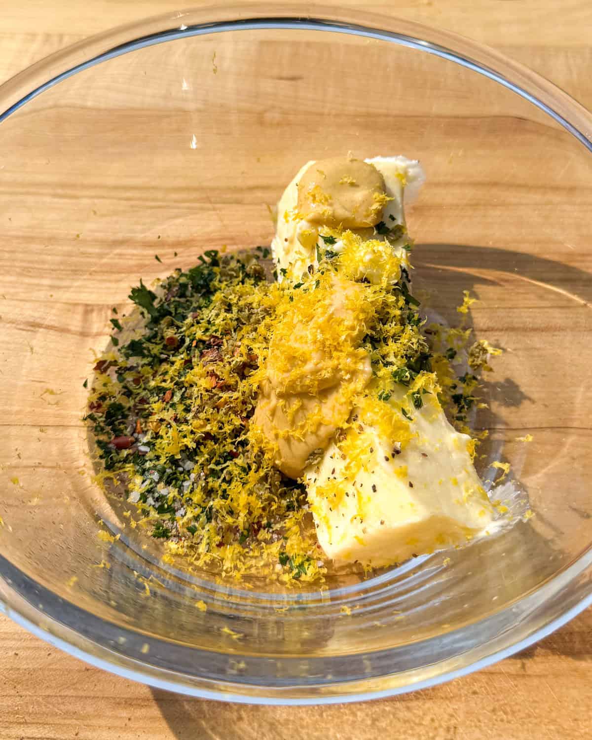 A bowl with Dijon butter ingredients about to get mixed.
