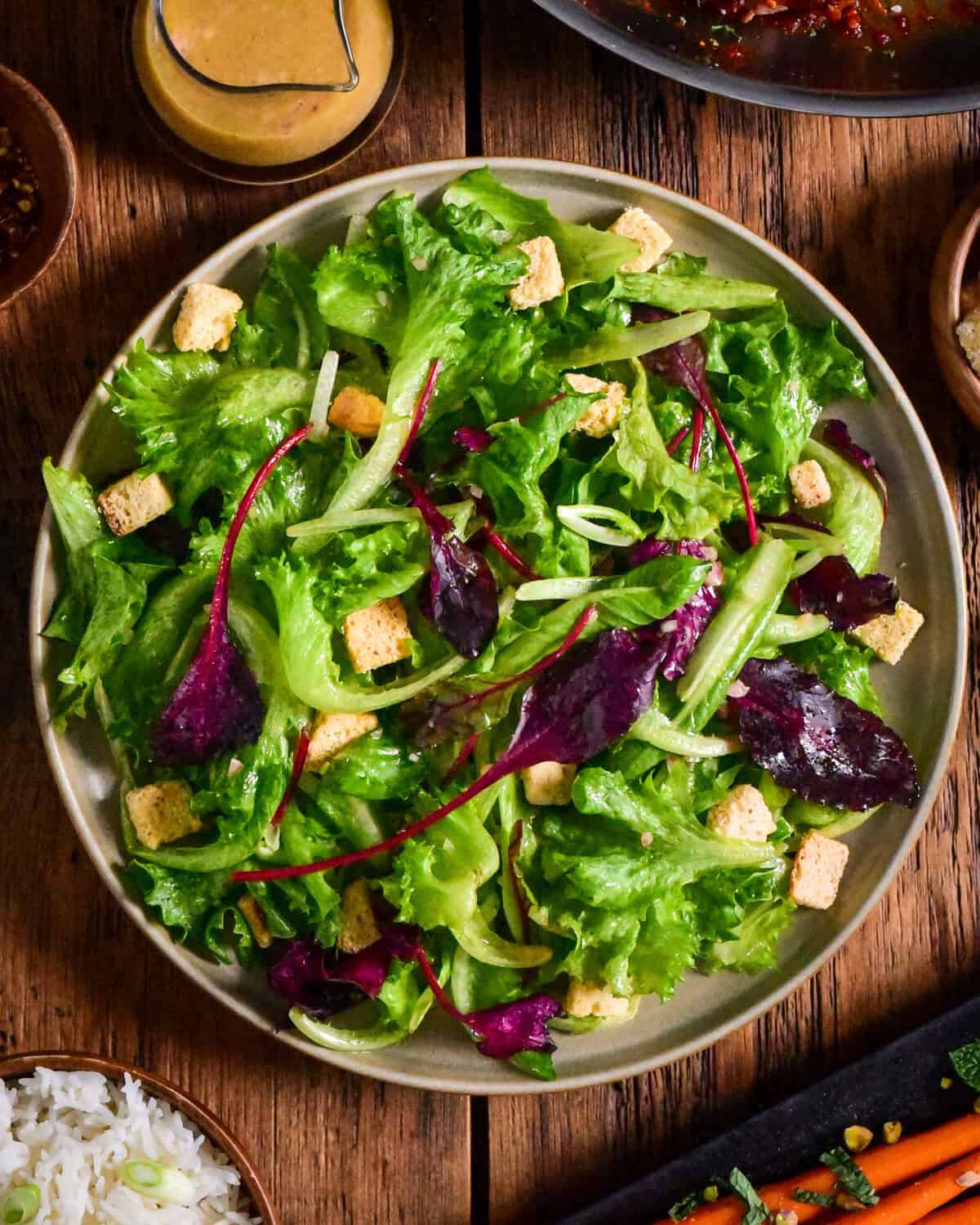 A simple green salad with croutons and a shallot vinaigrette.