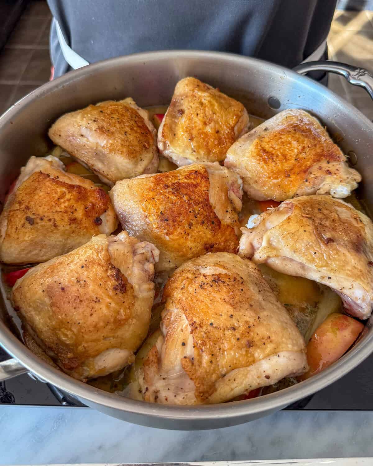 Place the thighs into the pot and simmer.