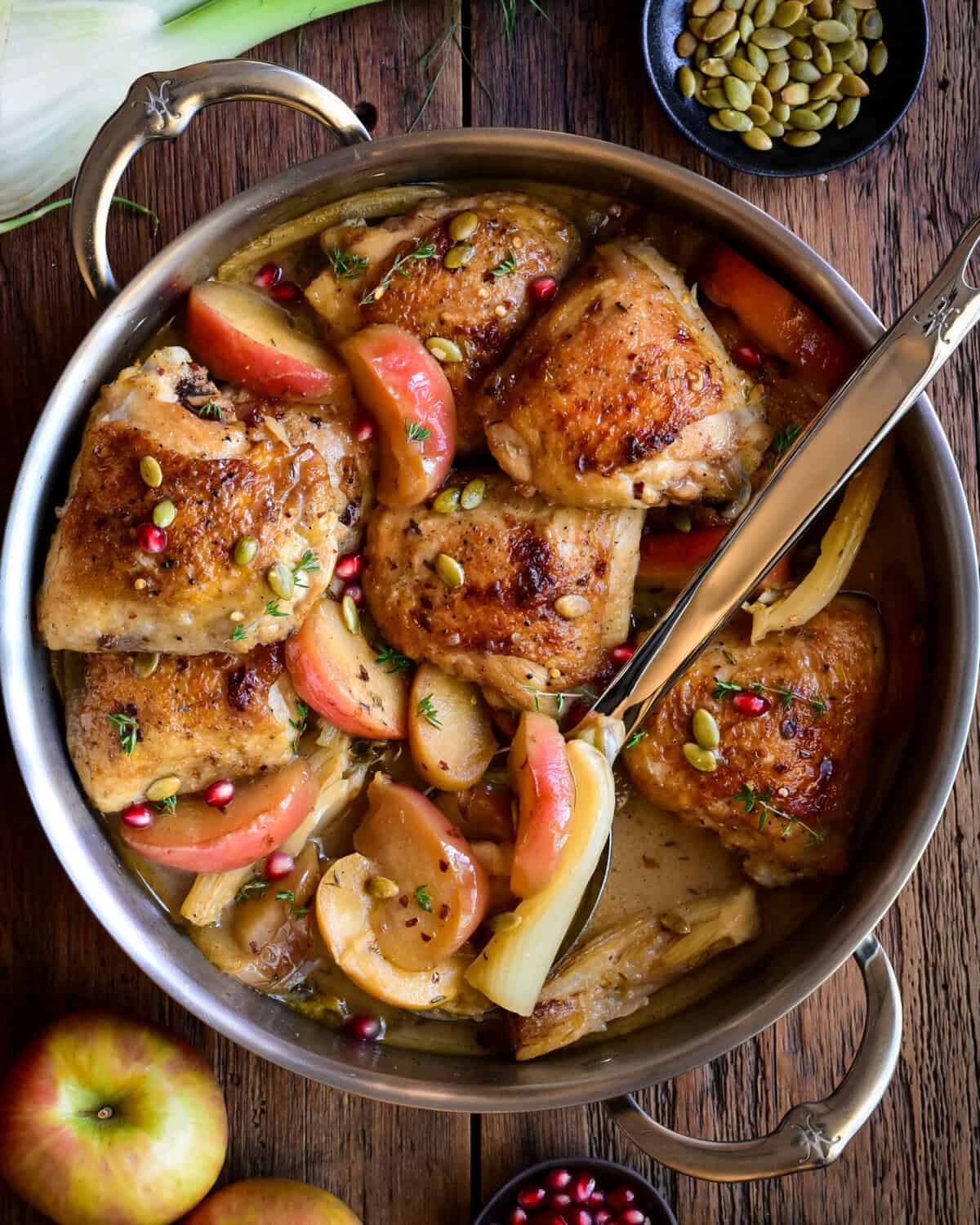A pot of Apple Cider Glazed Chicken with Apples and Fennel.