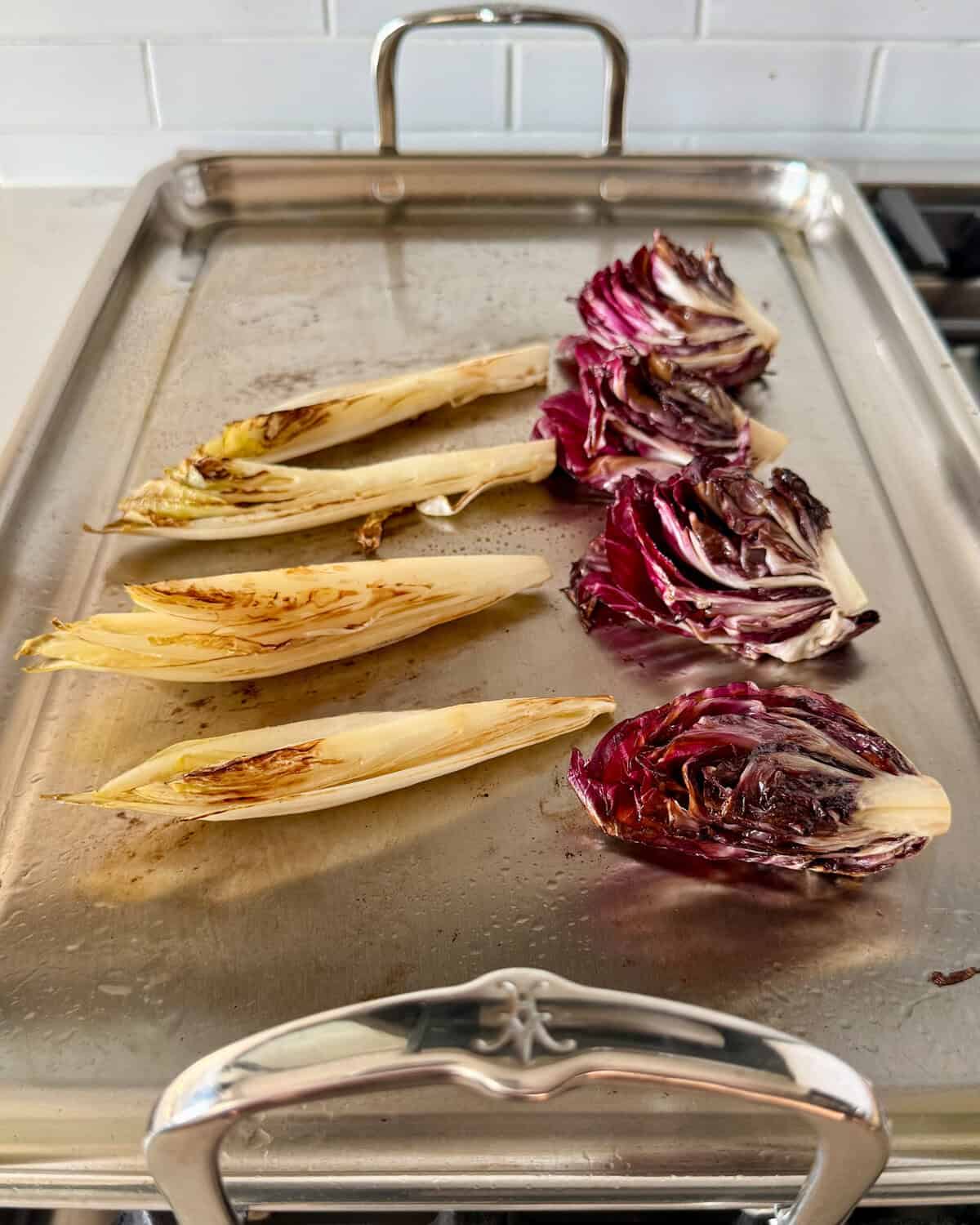 Charred radicchio and endive on a griddle.