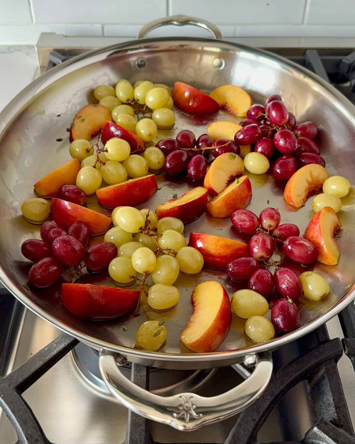 Add the peaches to the pan with the grapes to roast.