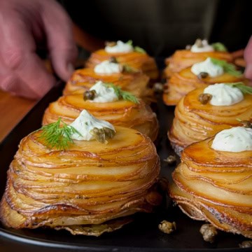 A close-up of Lemon–Dill Potato Stacks with Greek Yogurt & Capers.