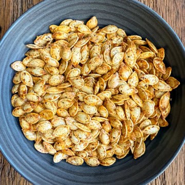 A bowl of Spicy Roasted Pumpkin Seeds with Paprika, Cayenne & Garlic.