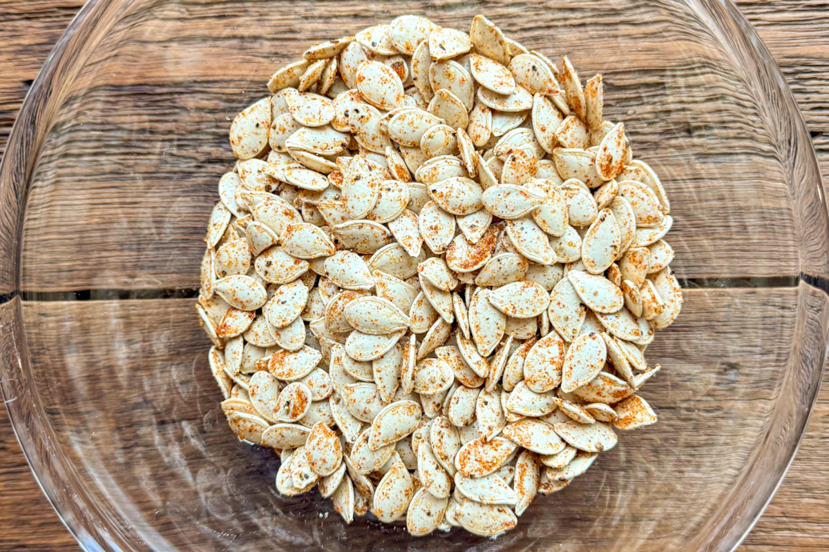 Season the pumpkin seeds with paprika, cayenne and garlic.