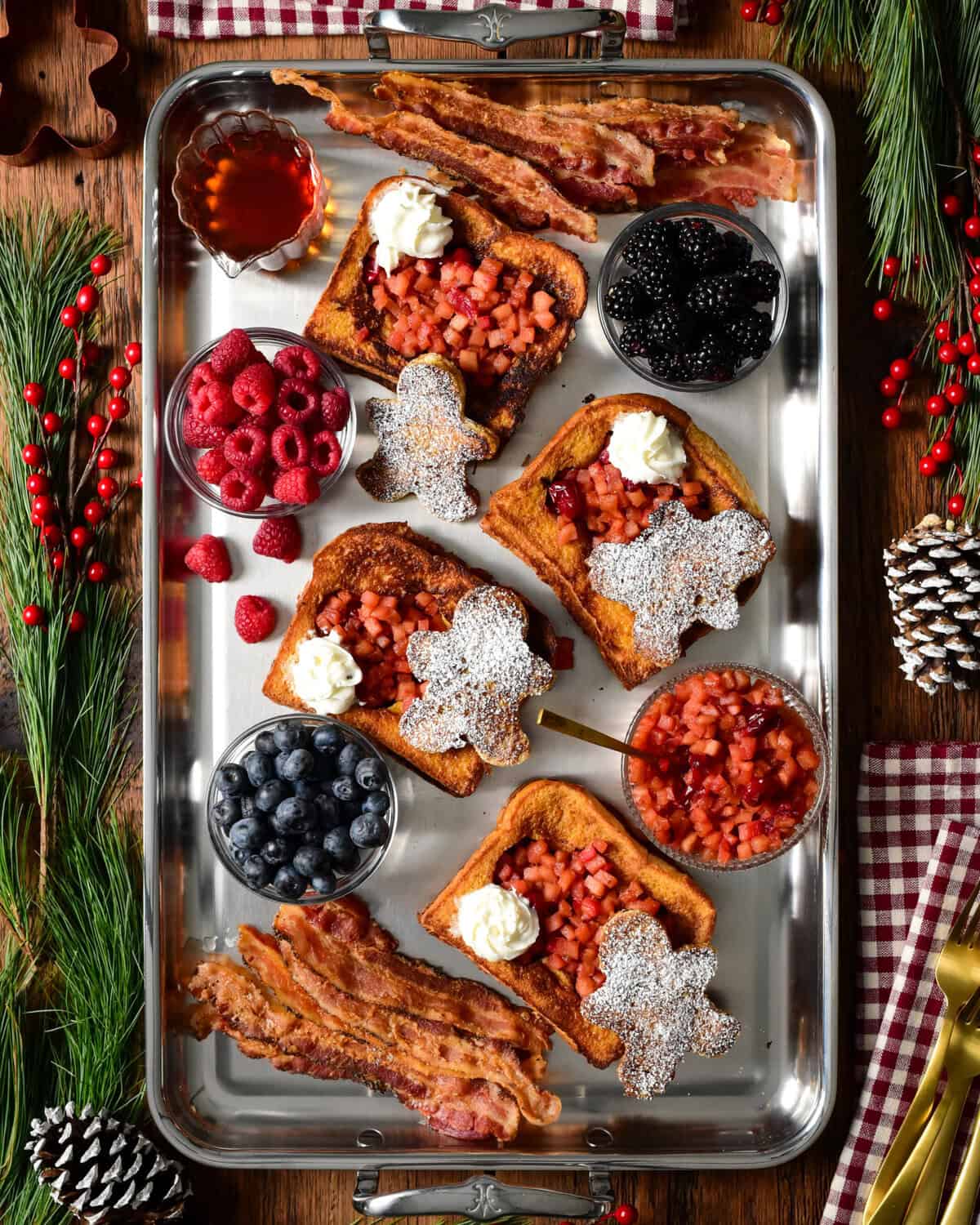 Gingerbread French Toast with Apple Cranberry Compote served with fresh berries and bacon.