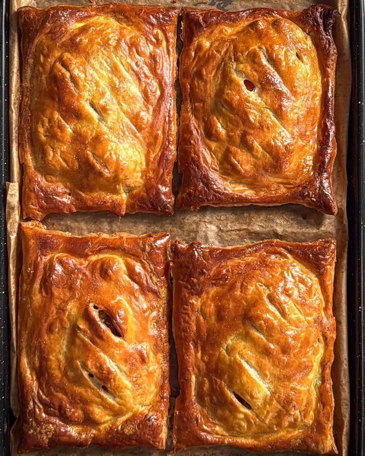 Four golden brown upside-down puff pastry.
