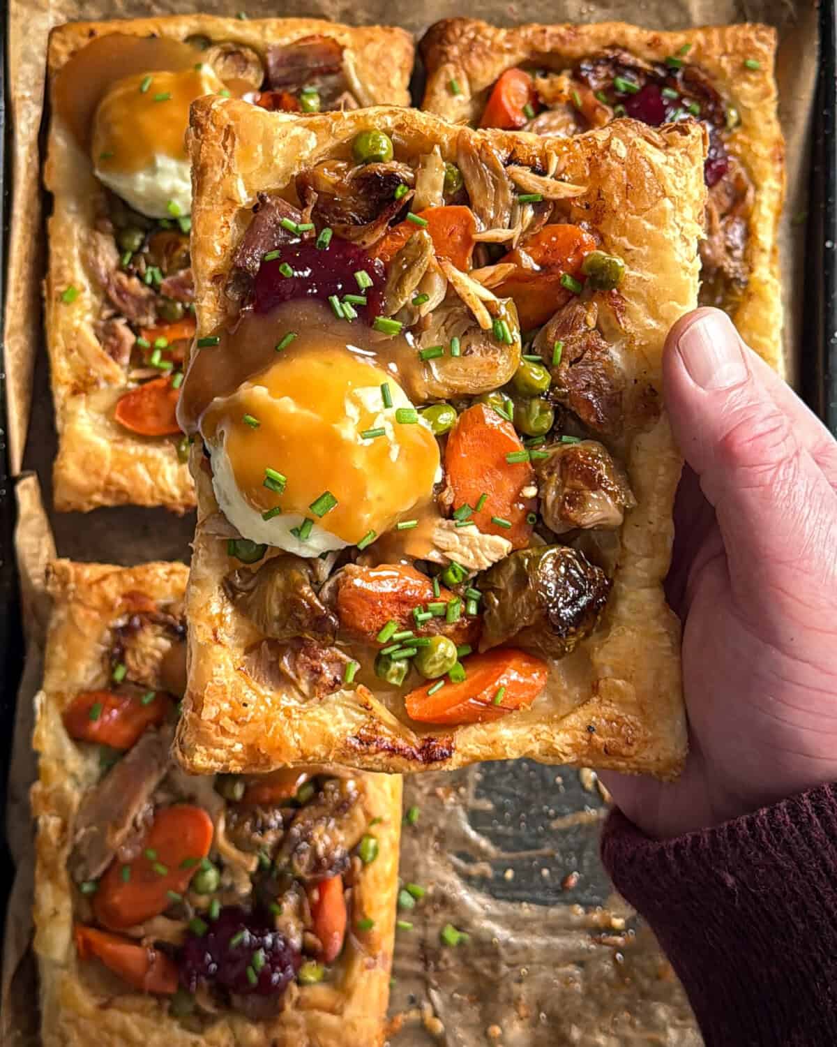 A close up of an upside down pastry with turkey leftovers.