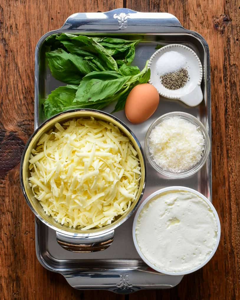 Ricotta and cheese layer ingredients for a meat lasagna.