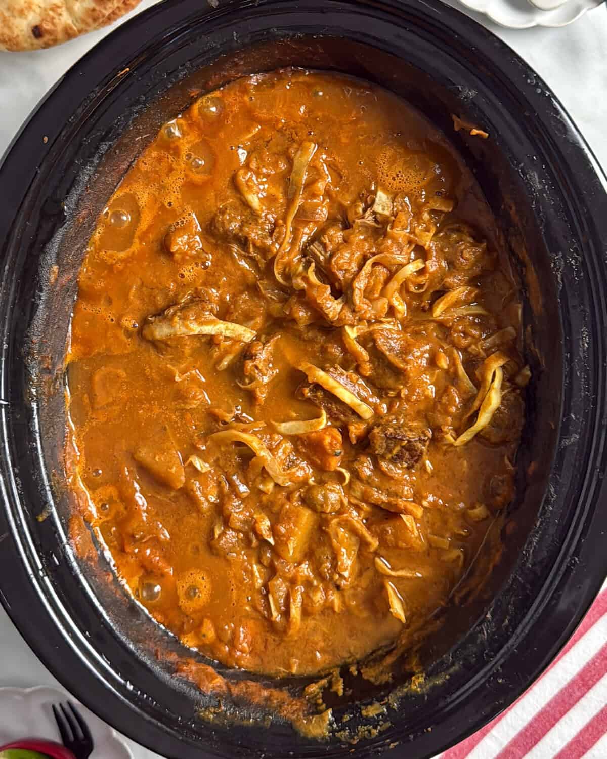 A pot of Slow Cooker Coconut Beef Curry With Winter Vegetables