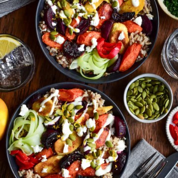 Two Winter Root Vegetable Bowls topped with Lemon Yogurt Dressing and pepitas.