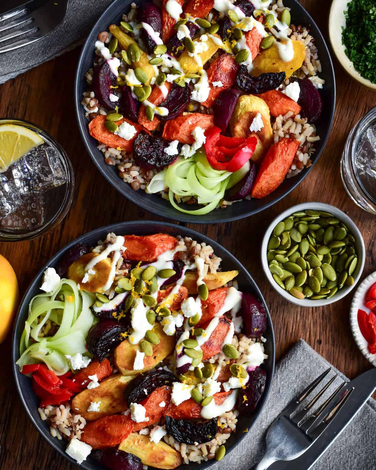 Two Winter Root Vegetable Bowls topped with Lemon Yogurt Dressing and pepitas.