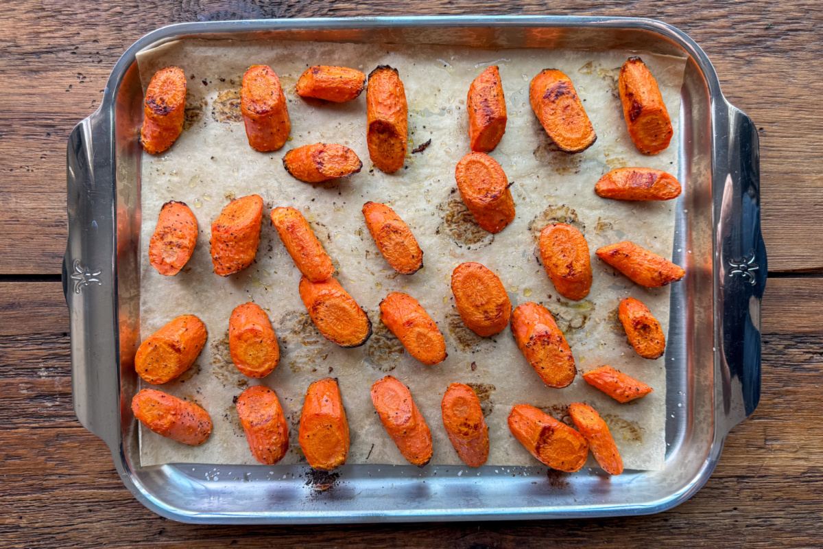 A sheet pan with roasted carrots.