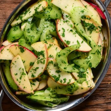 A crisp celery apple salad with lemon-parsley vinaigrette in an oval au gratin.