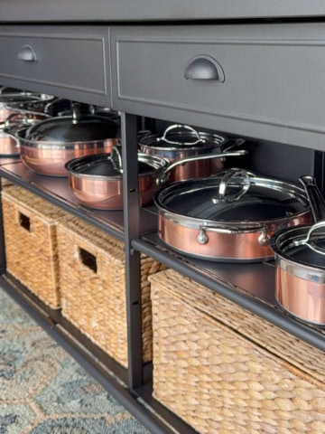 Hestan CopperBond Cookware on display in a kitchen island.