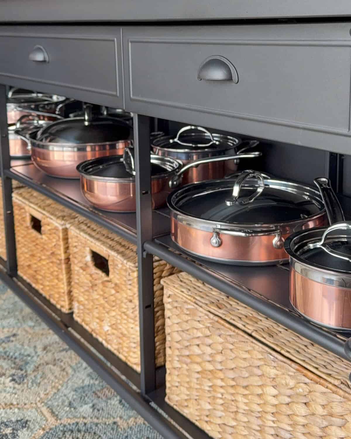 Hestan CopperBond Cookware on display in a kitchen island.
