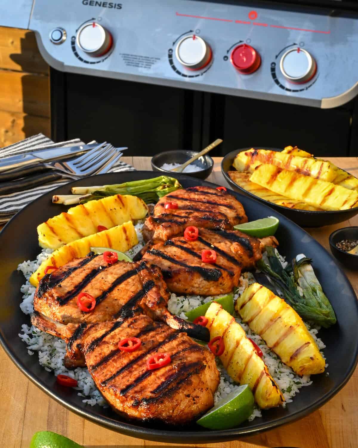 Chili-Lime Pork Chops with Grilled Pineapple served family-style over herb-lime jasmine rice.