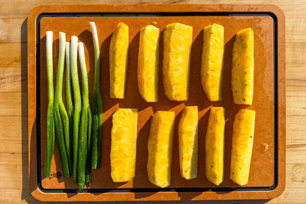 Toss the pineapple spears and scallions with olive oil, honey, and a pinch of salt until coated.