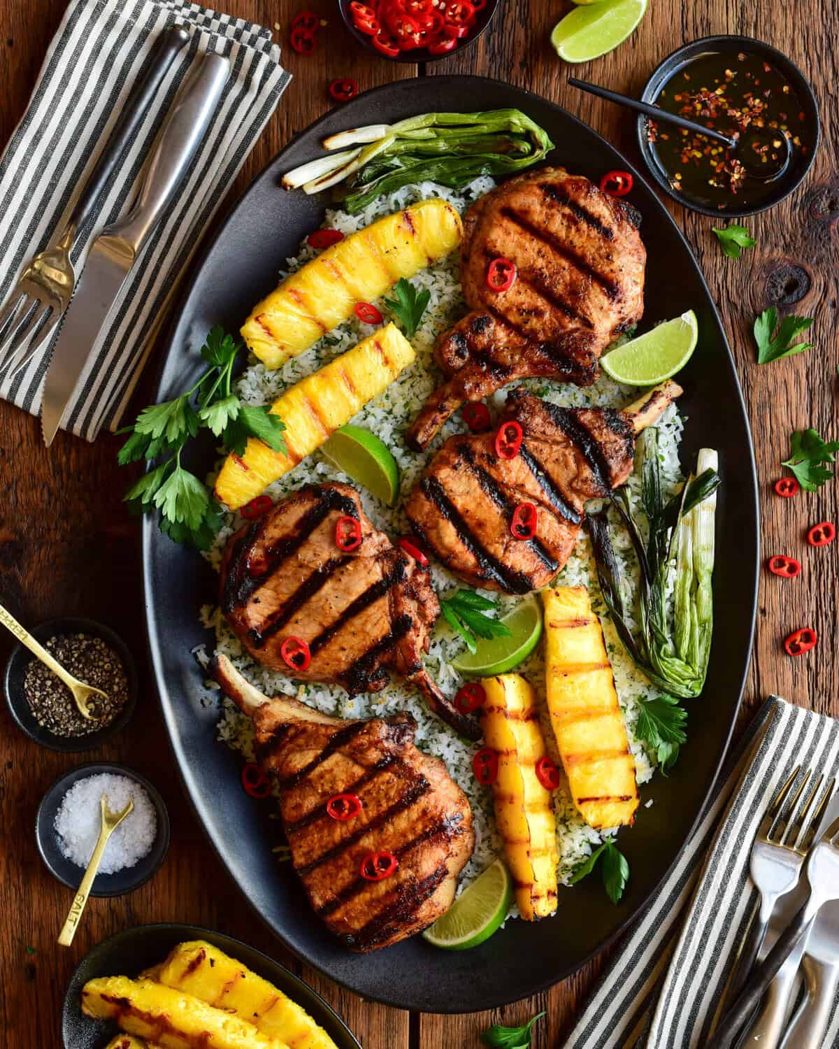 Chili-Lime Pork Chops with Grilled Pineapple served family-style over herb-lime jasmine rice.
