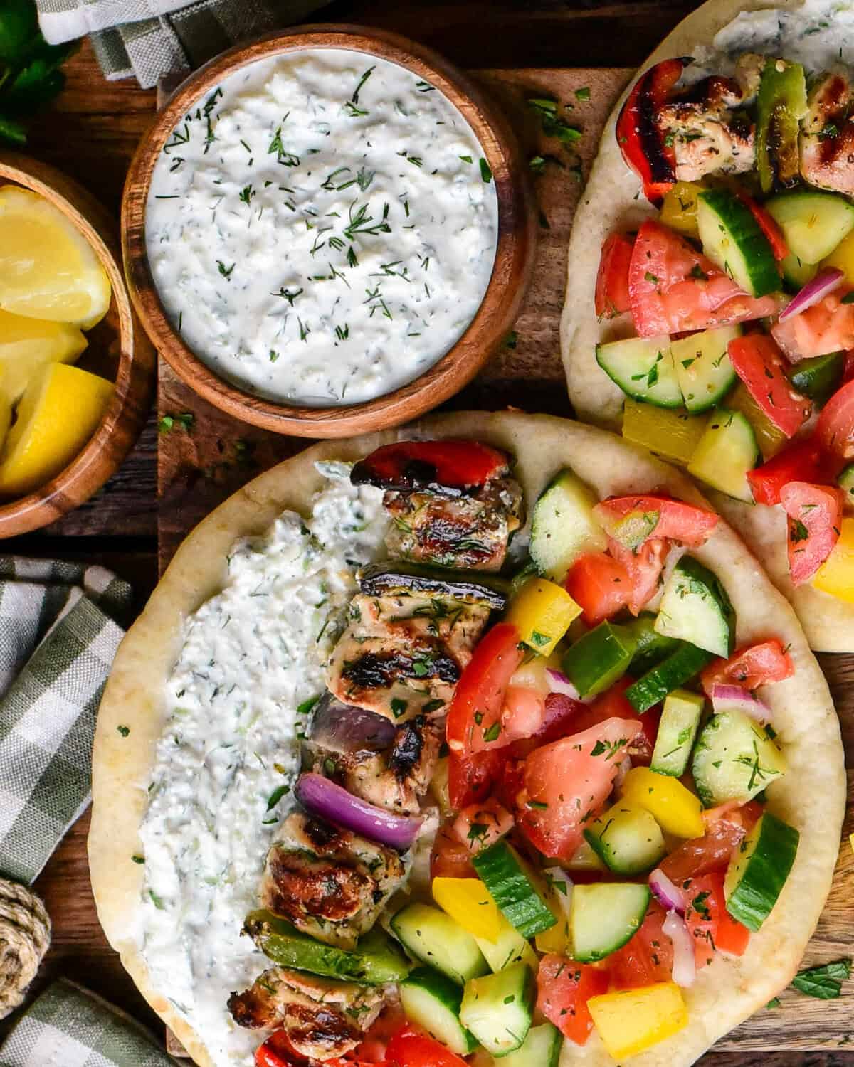A bowl of creamy whipped feta tzatziki served with a chicken souvlaki pita.