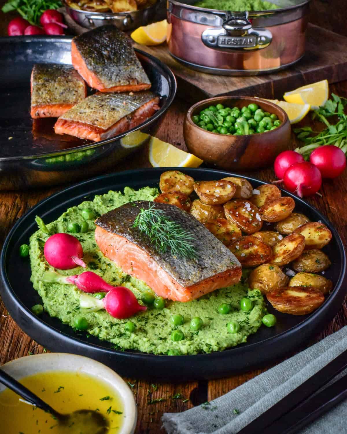 A dish served with Crispy Skin Salmon with Minty Pea Purée & Roasted Potatoes.