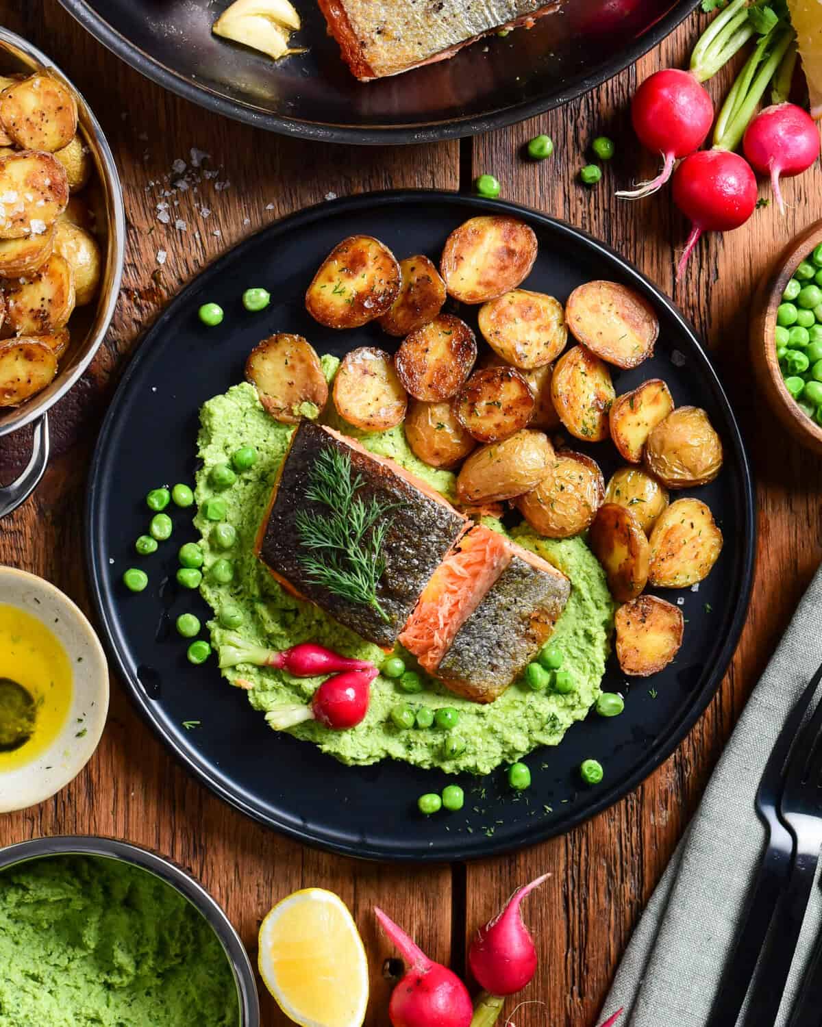 A dish served with Crispy Skin Salmon with Minty Pea Purée & Roasted Potatoes.