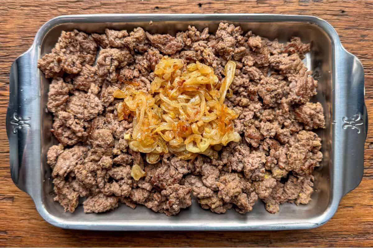 Transfer the beef to the plate with the onions.