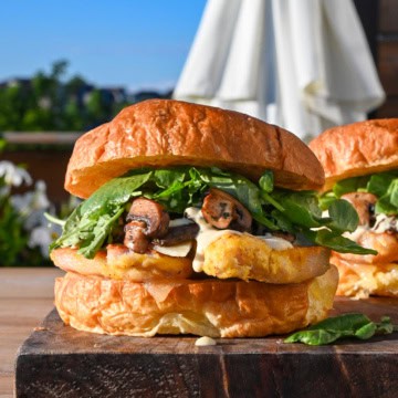 A Steakhouse Peameal Bacon Sandwich with Mushrooms, garlic aioli and greens.