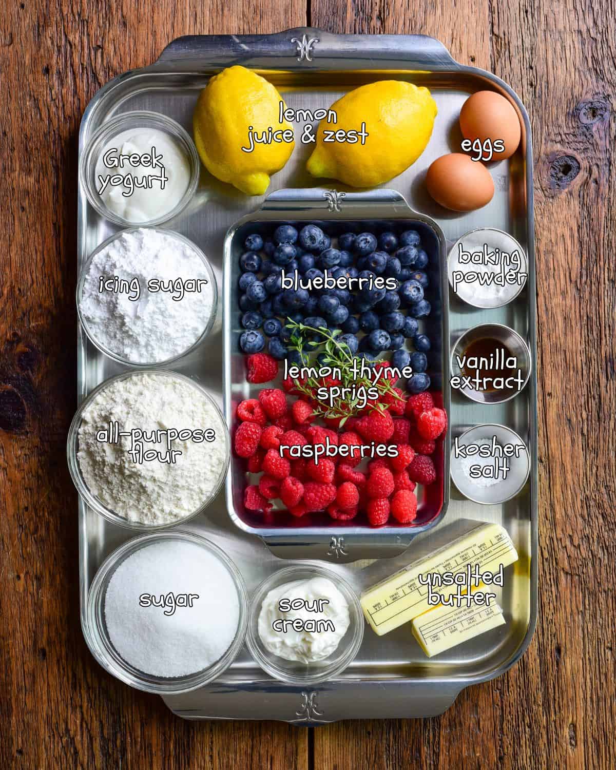 Ingredients for a lemon blueberry and raspberry cake with lemon glaze recipe.