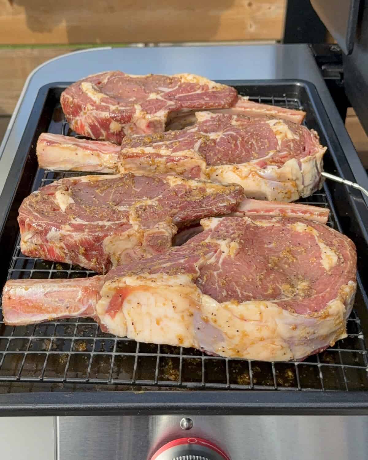 Take the veal chops out of the fridge and place them on a tray with a rack. Allow the marinade to drip off.