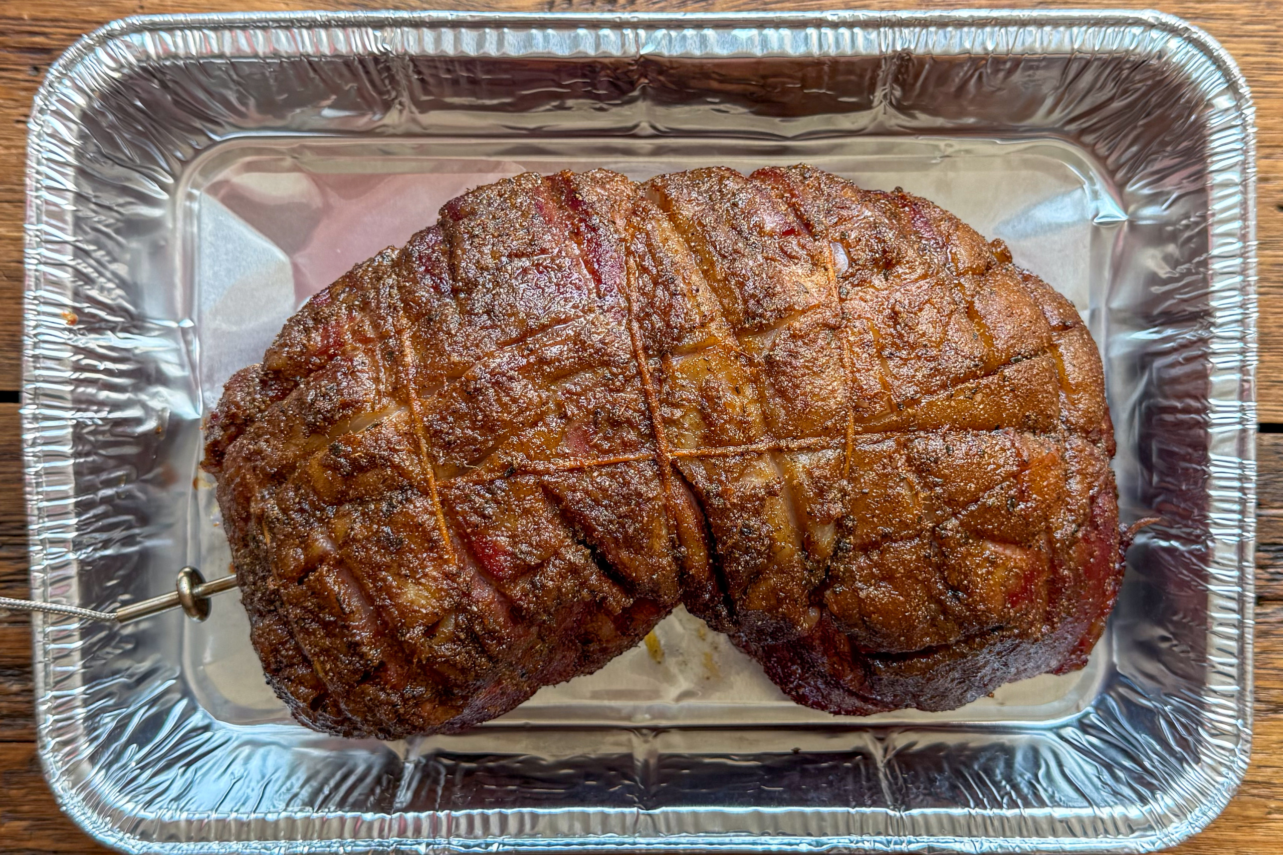 Place the smoked boneless leg of lamb in a tray when it has reached temperature in the low cook.