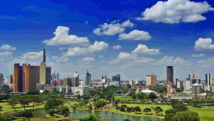 Nairobi cityscape featuring skyscrapers, green parks, and blue skies in Kenya's capital.