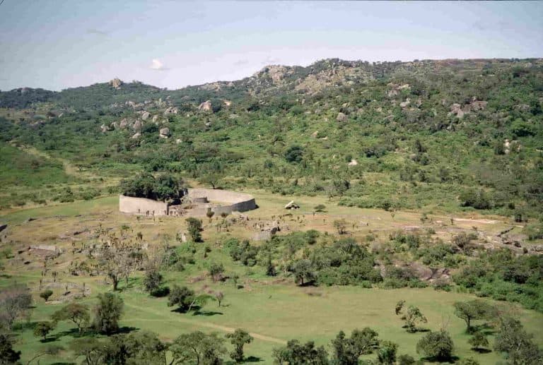 Small rural farm in East Africa with dry landscape and sparse vegetation.