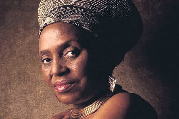 Portrait of an African woman wearing traditional headwrap and jewelry, showcasing classic African st.