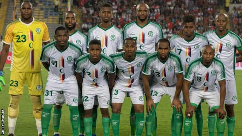 Comoros football team players in green and white jerseys on the field.