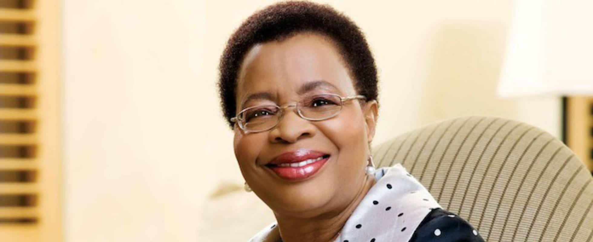 African woman smiling confidently at work.