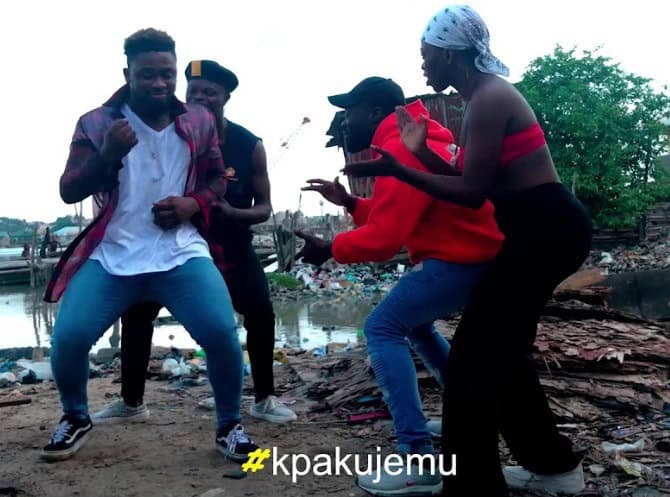 Young people dancing and having fun outdoors in an African community.