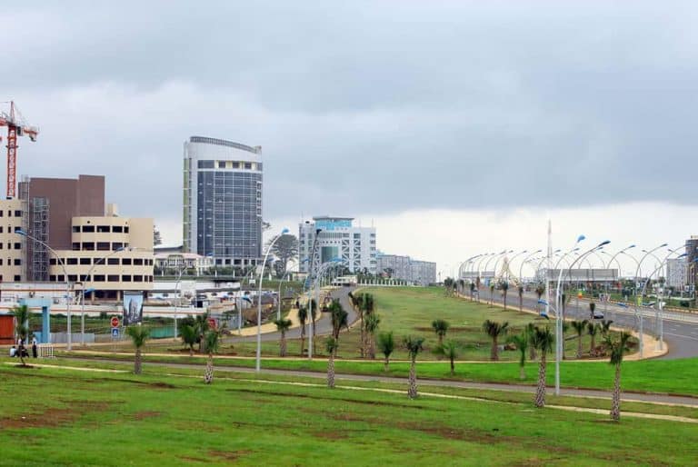 Urban skyline of Malabo featuring contemporary buildings and lush green spaces.