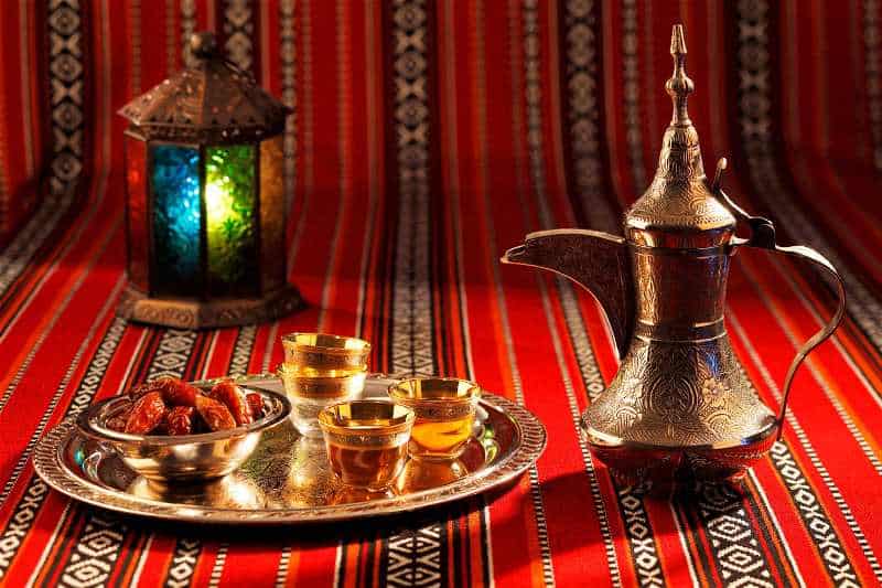 Authentic Egyptian tea service with dates, ornate teapot, and decorative lantern for cultural ambian.