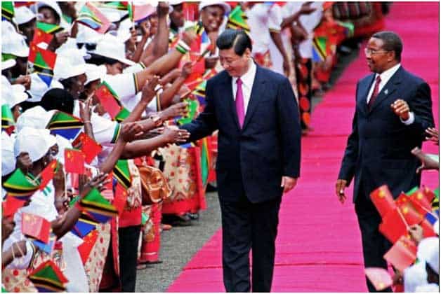Chinese leader greeting African citizens during official visit, promoting China-Africa relations.
