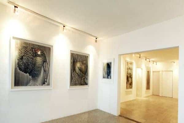 African art pieces displayed in a modern gallery setting emphasizing vibrant traditions.