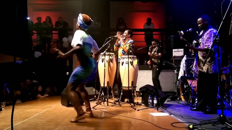 Angolan musicians perform traditional and modern music at a lively concert.