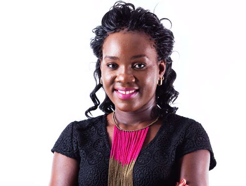 African woman in professional attire, representing women in technology.