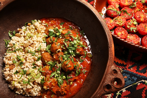Traditional African vegetable and meat stew with herbs and spices in a rustic bowl.